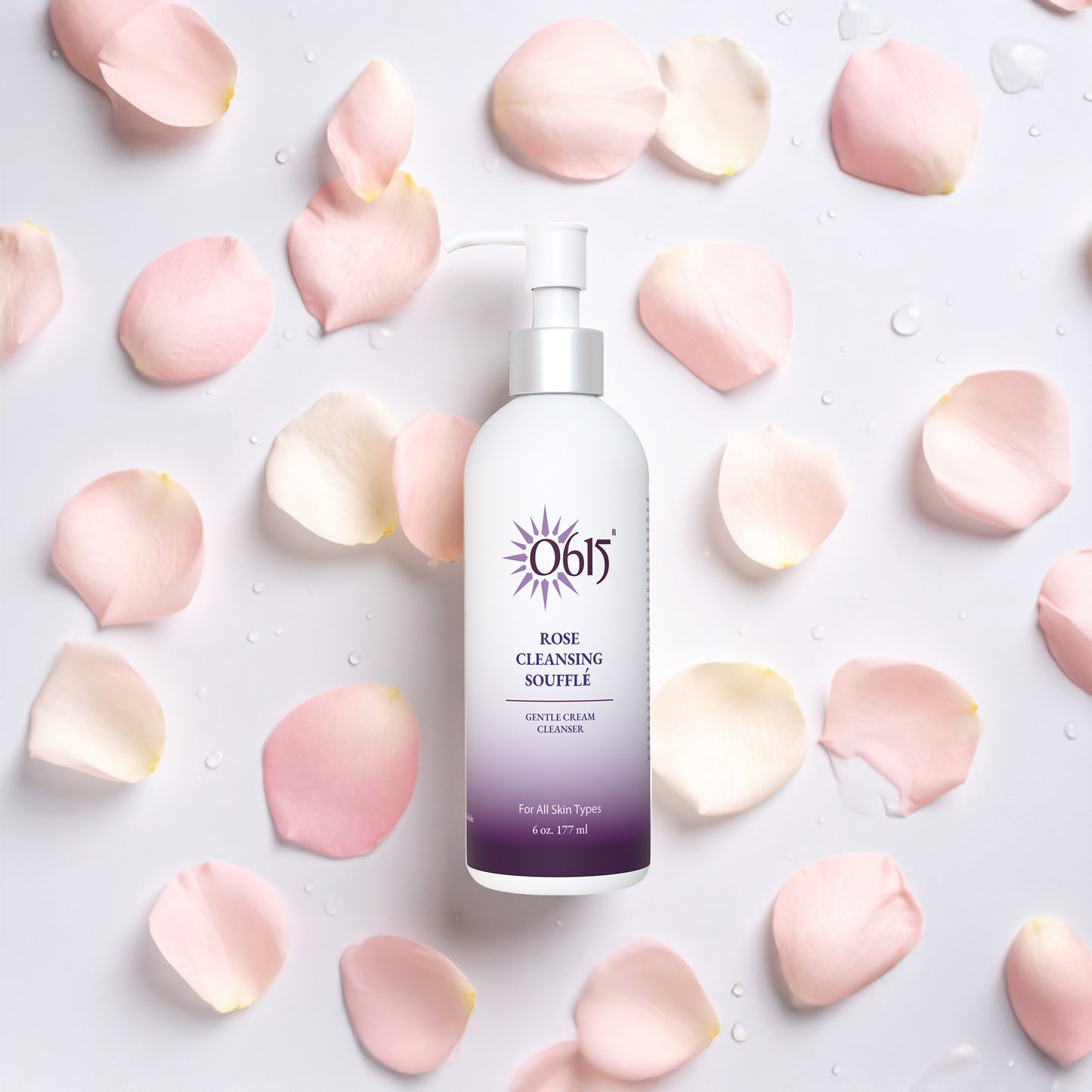 Rose Cleansing Souffle bottle surrounded by pink rose petals on a light background