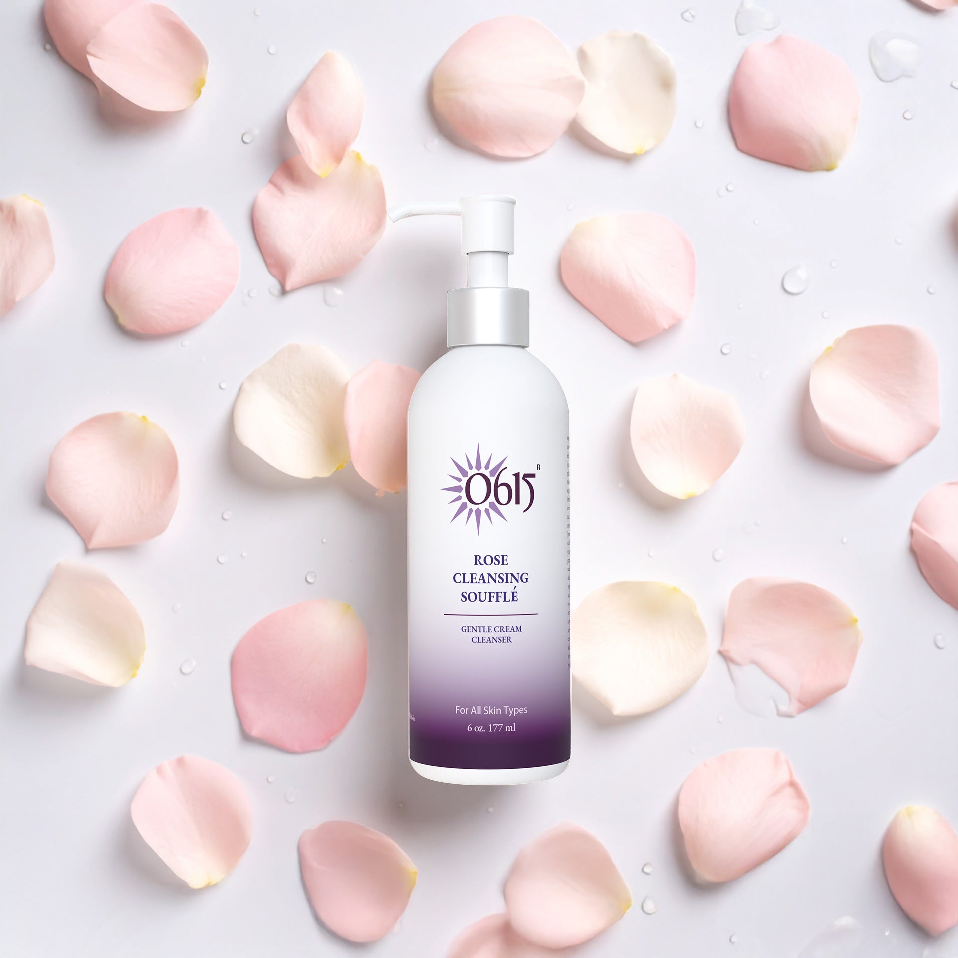 Rose Cleansing Souffle bottle surrounded by pink rose petals on a light background