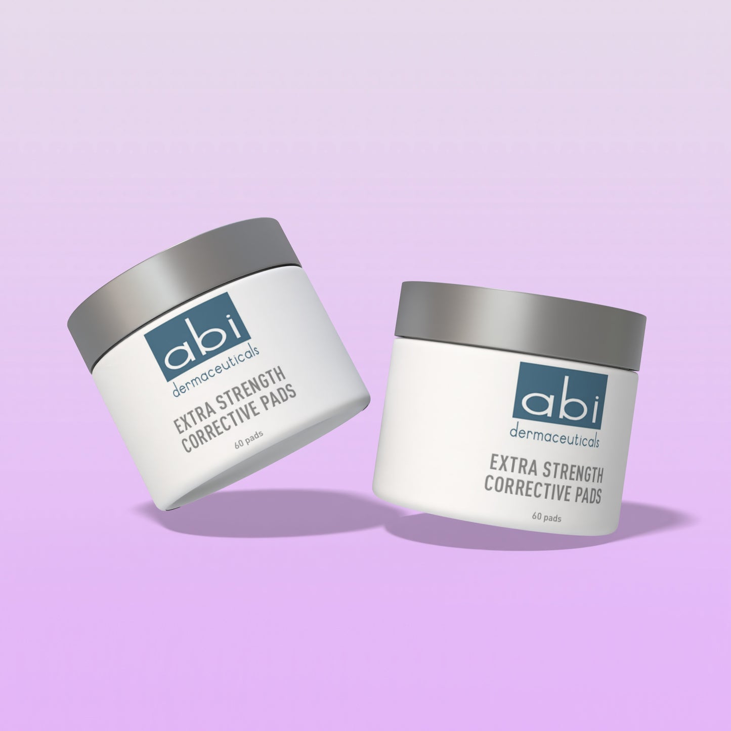 Two containers of abi dermaeuticals Extra Strength Corrective Pads on a light purple background