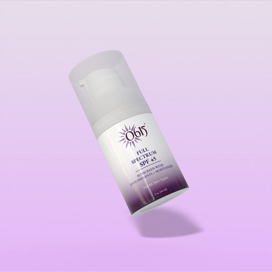 Sunscreen bottle on a light purple background